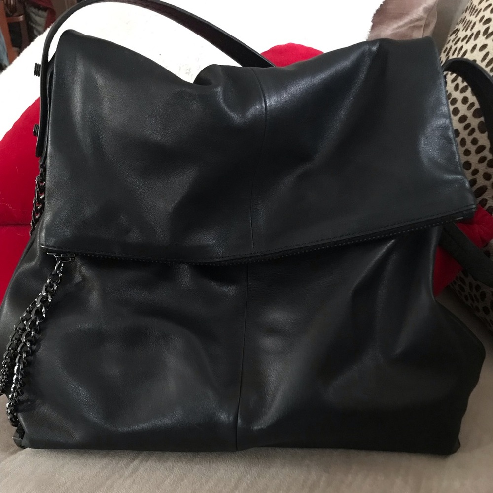 Black leather handbag with metal detailing.